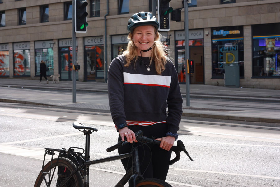 Eslpeth stands with her bike next to the cycle lane on Leith Walk, Edinburgh