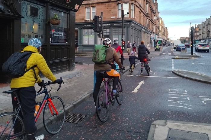 Annalise and her son wait at traffic lights on the South City Way cycle route in Glasgow