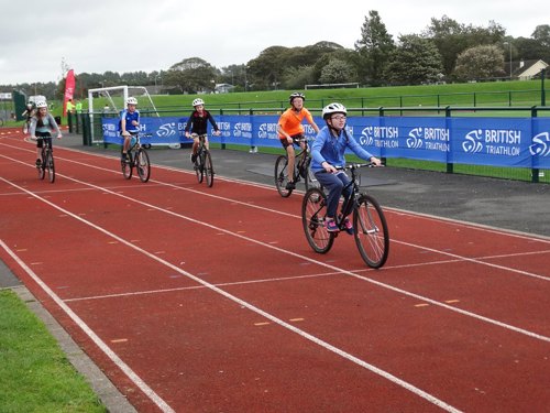 Pupils of Stranraer Academy riding their bikes in the school's sports field