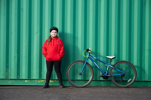 Maeci, a pupil at Ferryhill Primary School stands next to her bike in the school playground