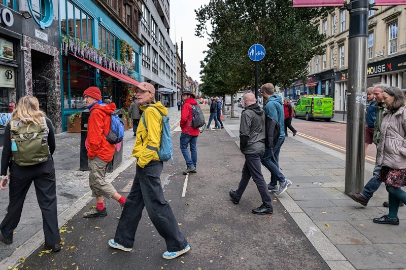 A group of people take part in a walking tour of the Glasgow Avenues project on Sauchiehall Street