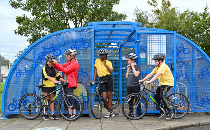 Schoolchildren gather their bikes from the school bike shelter ahead of a Bikeability Scotland cycle training session