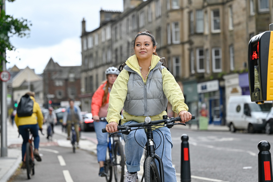 People cycling on the CCWEL cycle route in Roseburn, Edinburgh