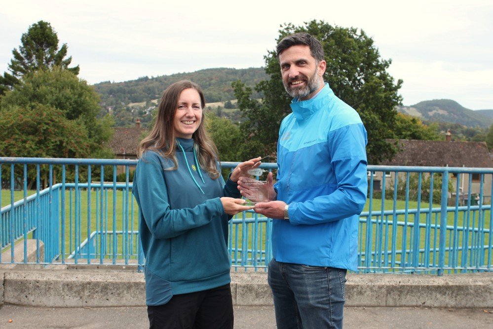 Kelly Fry is presented the Bikeability Scotland Annual Achievement award trophy by David Collins, Bikeability Scotland Manager at Cycling Scotland