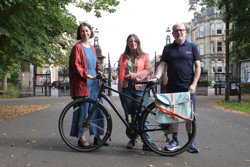 Katherine Cory, Cycling Champion of the Year 2025 (centre), pictured with Clare Skelton-Morris (Cycling Scotland, left) and Paul Jones (Scottish Cycling, right)