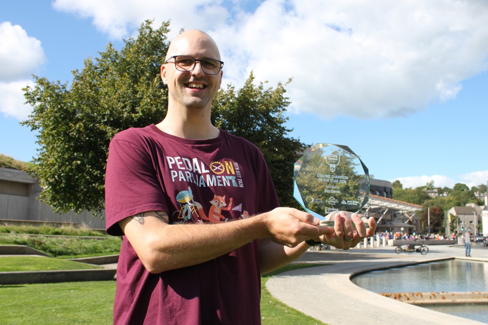 Cycling Champion of the Year 2026, Ben Seven, pictured in front of the Scottish Parliament