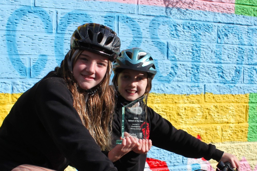 Two pupils from Corstorphine Primary in Edinburgh with their Bikeability Scotland School of the Year 2026 award trophy